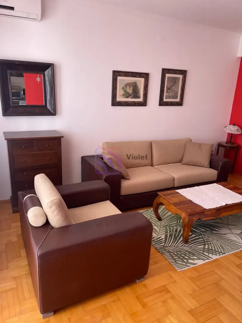 Living room with sofa set, coffee table, and chest of drawers.