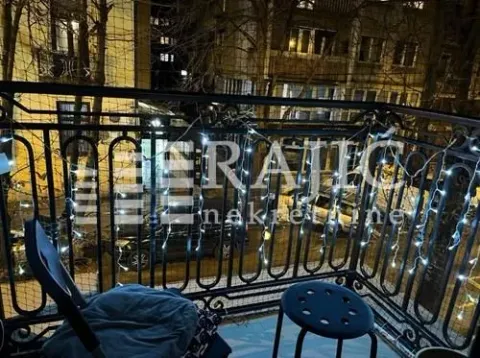 Balcony with decorative lighting and a view of surrounding buildings. - image 13
