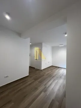 Empty room with light-colored walls and wooden flooring. - image 3