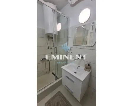 Smaller bathroom with a shower cabin, washbasin, and mirror. - image 12