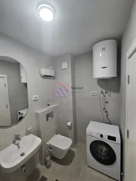 Moderne kupatilo sa umivaonikom, toaletom, bojlerom i veš mašinom obloženo sivo-bež pločicama. - image 14