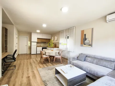 Open-plan living room with dining area and kitchen in the background. - image 13