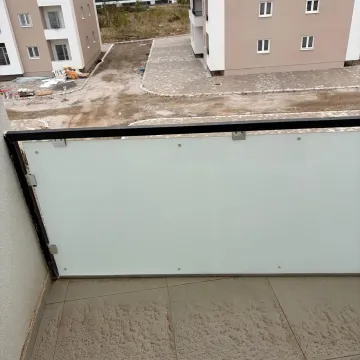 View from the balcony overlooking surrounding buildings and courtyard. - image 10