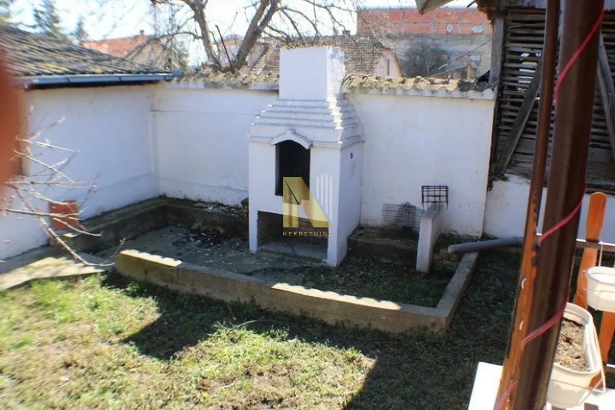 Yard of the house with a built-in barbecue.