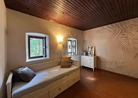 Furnished bedroom with a bed and a wooden ceiling. - image 7