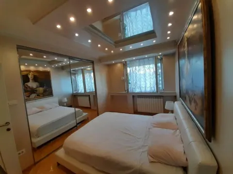 Bedroom with a double bed, a large mirror, and recessed ceiling lighting. - image 8
