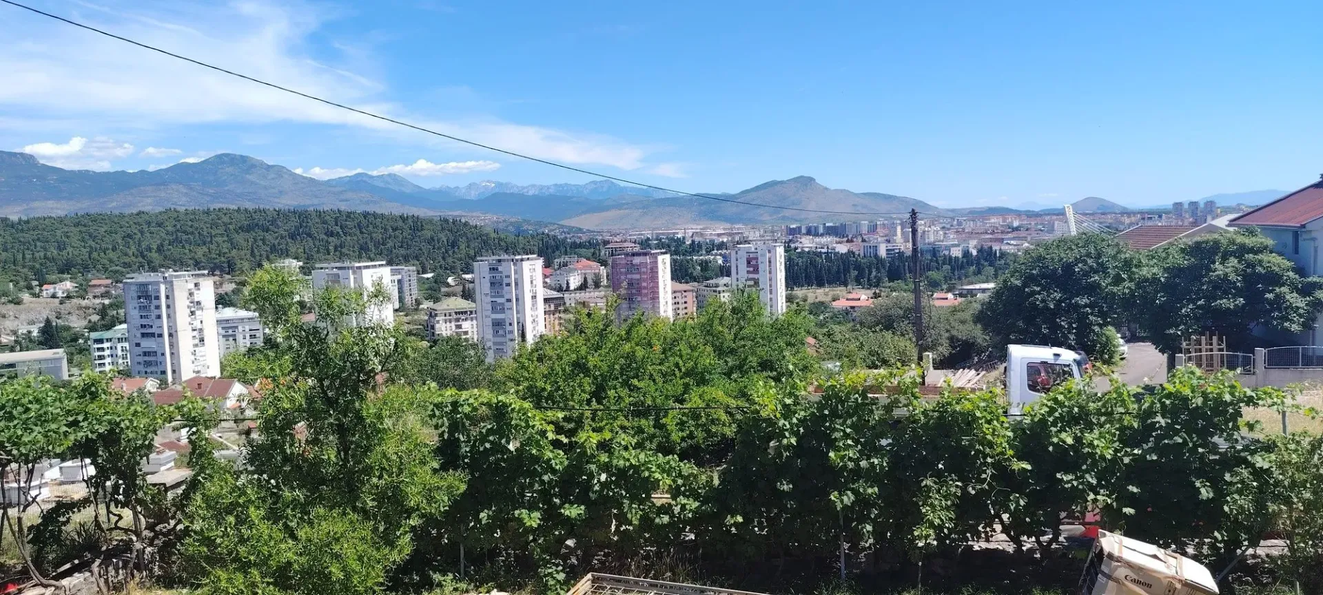 View from the terrace towards the city and mountains in the background.