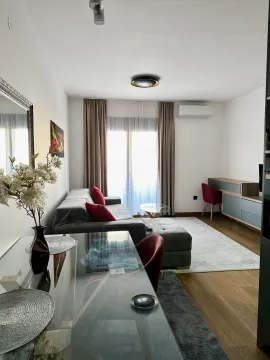 Living room with a sofa, dining table, and workspace. - image 4