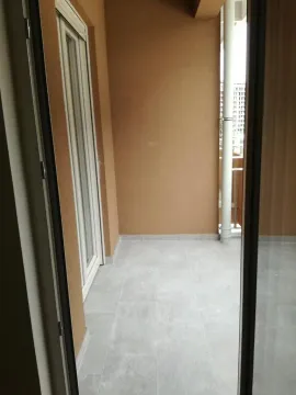 View of an unfurnished balcony with grey ceramic tiles. - image 2