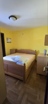 Bedroom with a double bed and yellow walls. - image 5