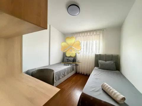 Bedroom with two single beds and a desk. - image 13