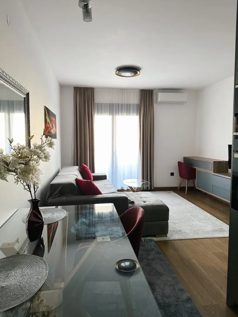 Modern living room with a sofa and dining table.