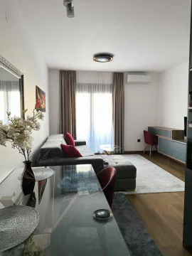 Modern living room with a sofa and dining table. - image 3
