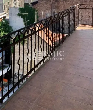 Spacious tiled terrace with metal railing and view of surrounding buildings. - image 9