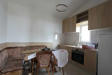 A kitchen with a dining table. - image 7