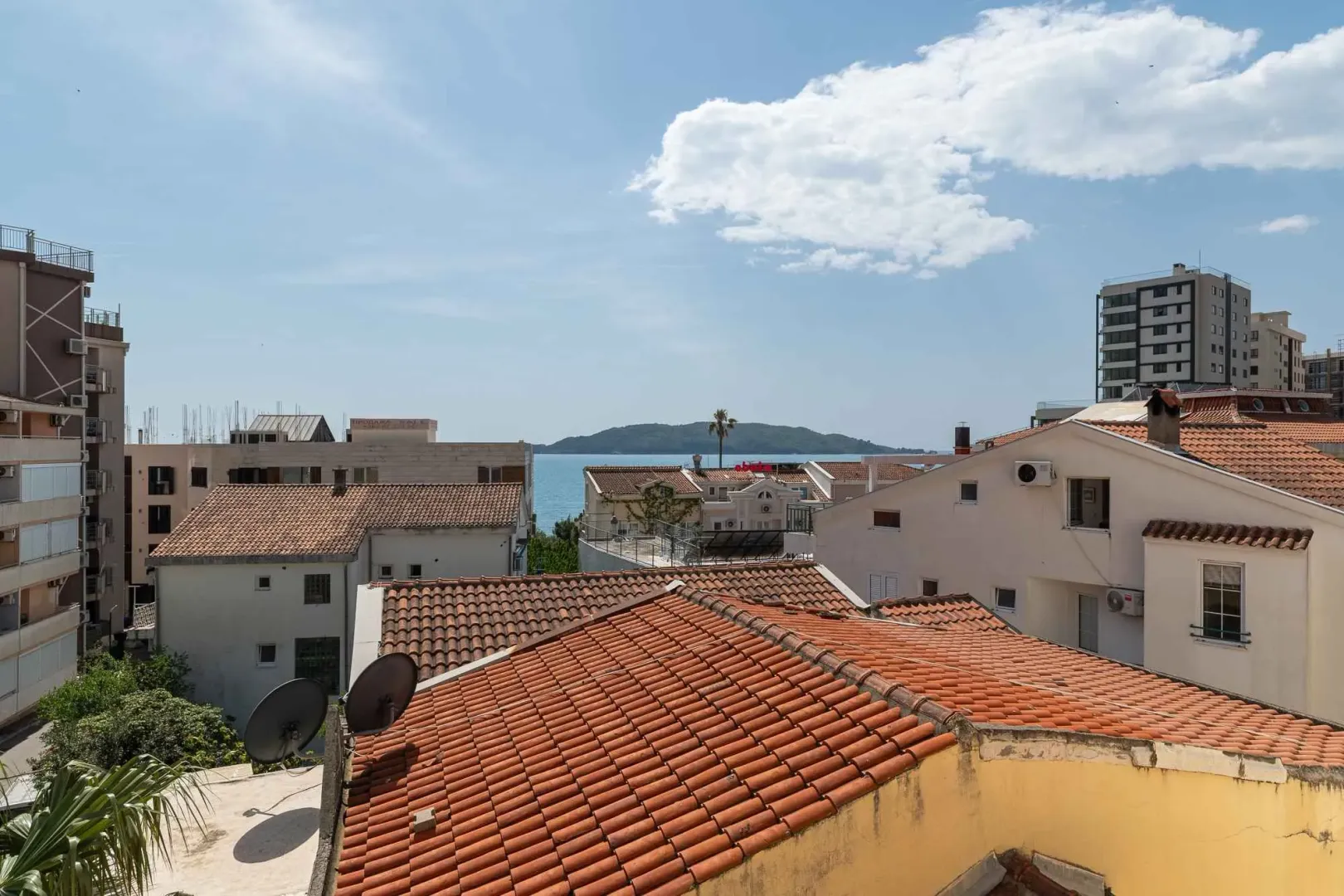 View from the terrace overlooking rooftops and the sea.
