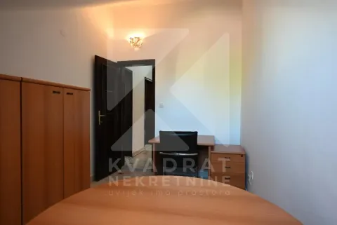 Small room with a desk, wardrobe, and an open door. - image 11