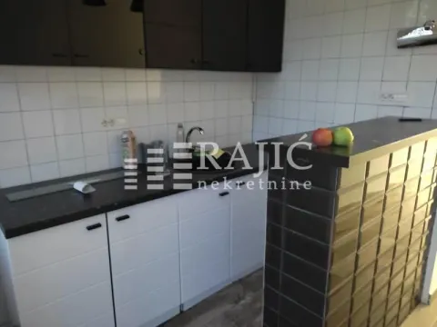View of a modern kitchen equipped with a bar counter. - image 7