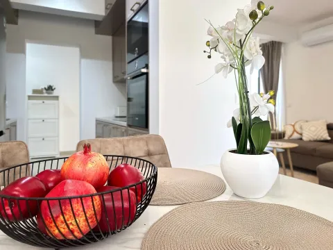 Dining table with a fruit basket and decorative plant in the interior. - image 12