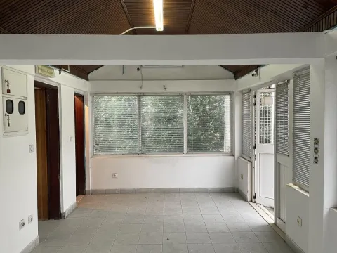 Empty room with tiled floor and windows. - image 2