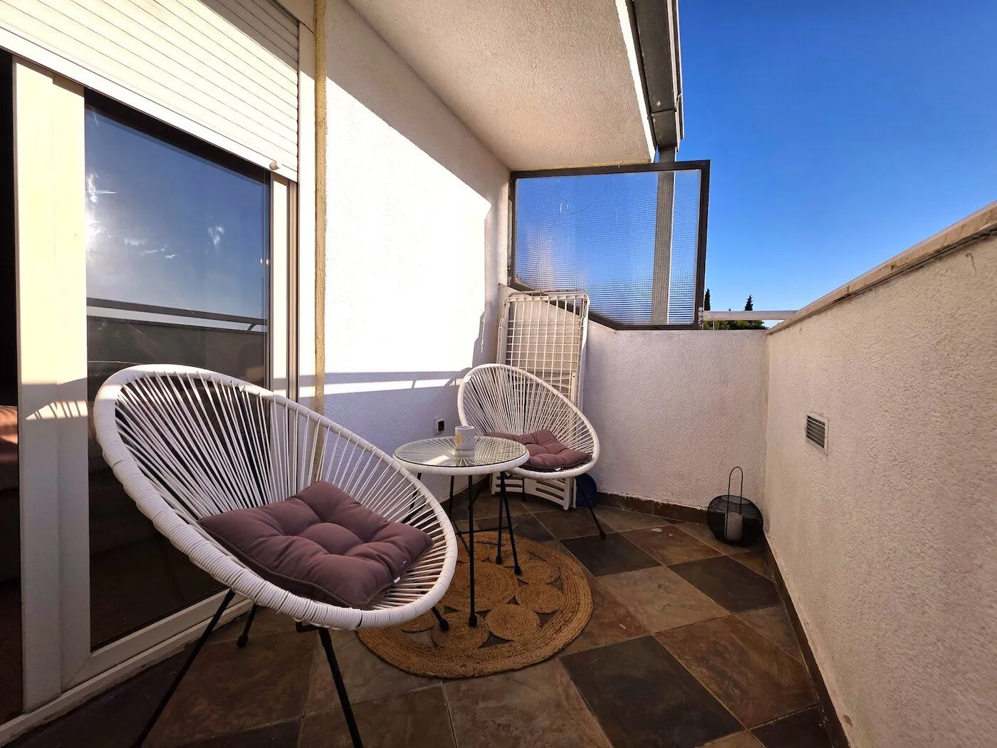 Furnished terrace with a table and two chairs.