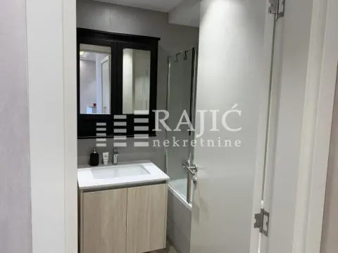 View of a modern bathroom with a vanity and mirror. - image 12