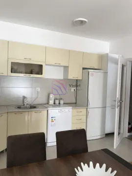Kitchen equipped with light-coloured cabinets and white appliances. - image 6