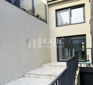 Eksterijer moderne kuće sa popločanim dvorištem i metalnom ogradom. - image 6