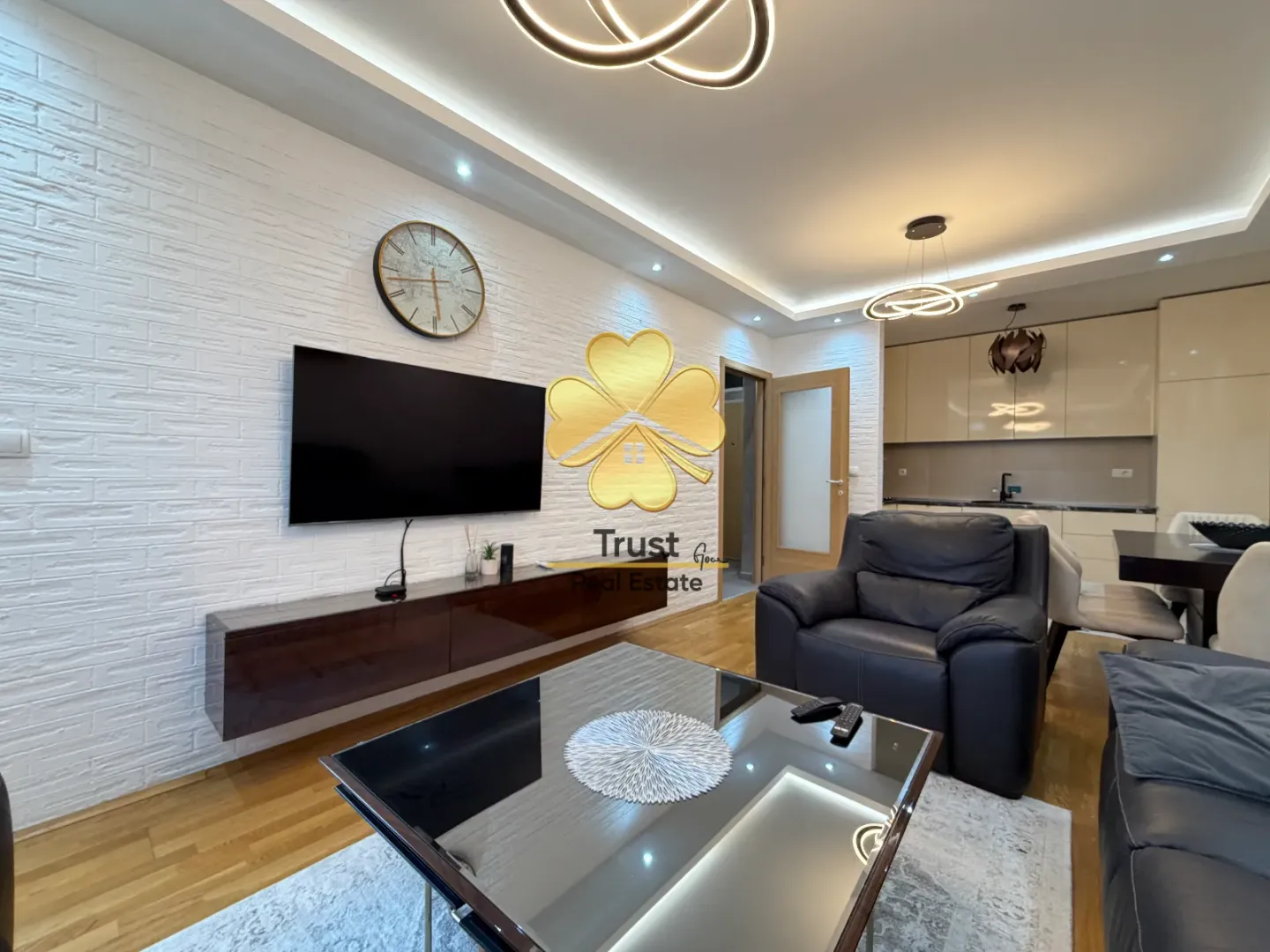 Living room with furniture, TV, and dining area in the background.