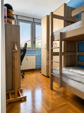 Children's bedroom with a bunk bed, wardrobes, and a desk. - image 6