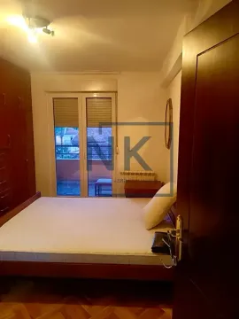 Furnished bedroom with a double bed, wardrobe, and balcony access. - image 3