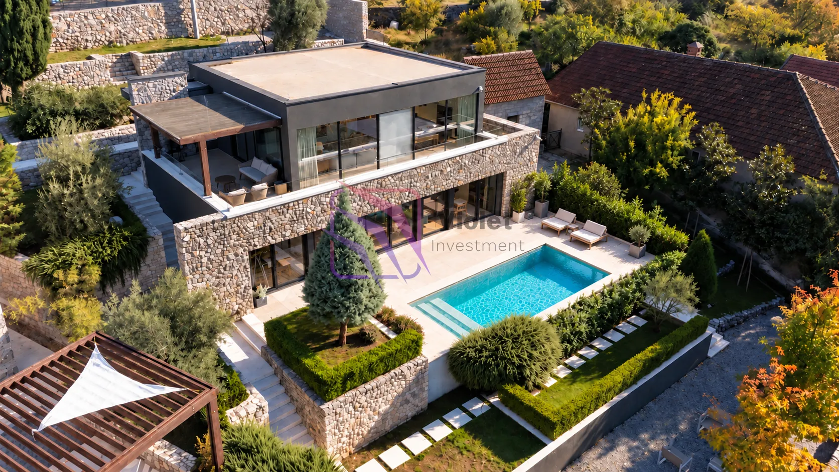 Aerial view of a modern villa with a swimming pool and landscaped yard.