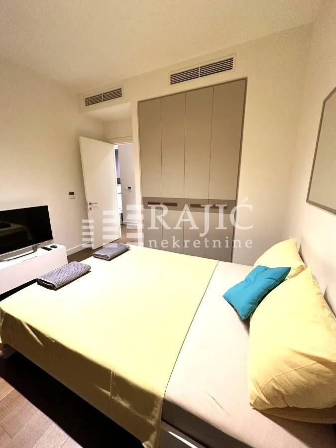 Furnished bedroom with a double bed and built-in wardrobe.