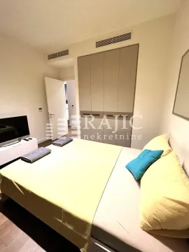 Furnished bedroom with a double bed and built-in wardrobe. - image 8