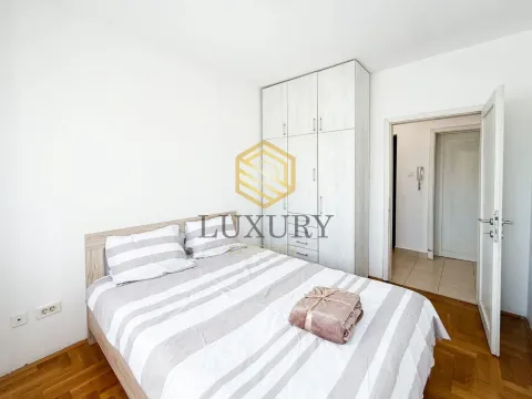 Bedroom with a double bed, wardrobe, and wooden flooring. - image 2