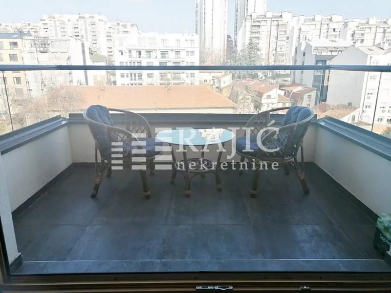 Furnished terrace with seating set and city view.