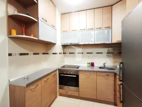 Kitchen equipped with wooden cabinetry and built-in appliances. - image 5