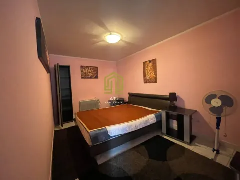 Furnished bedroom with a double bed and pink walls. - image 7