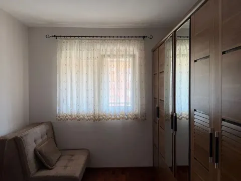 Small bedroom with a sofa, window, and built-in wardrobe. - image 5