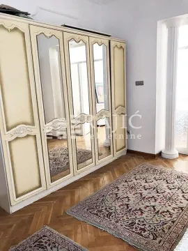 Bedroom with a large wardrobe and parquet flooring. - image 8