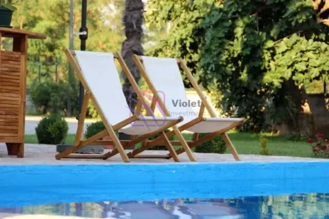 Sun loungers by the pool in a green yard. - image 7
