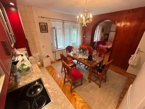 Dining area with a wooden table and chairs connected to the kitchen. - image 16