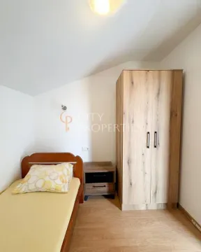 Small bedroom with a bed, nightstand, and wardrobe. - image 5