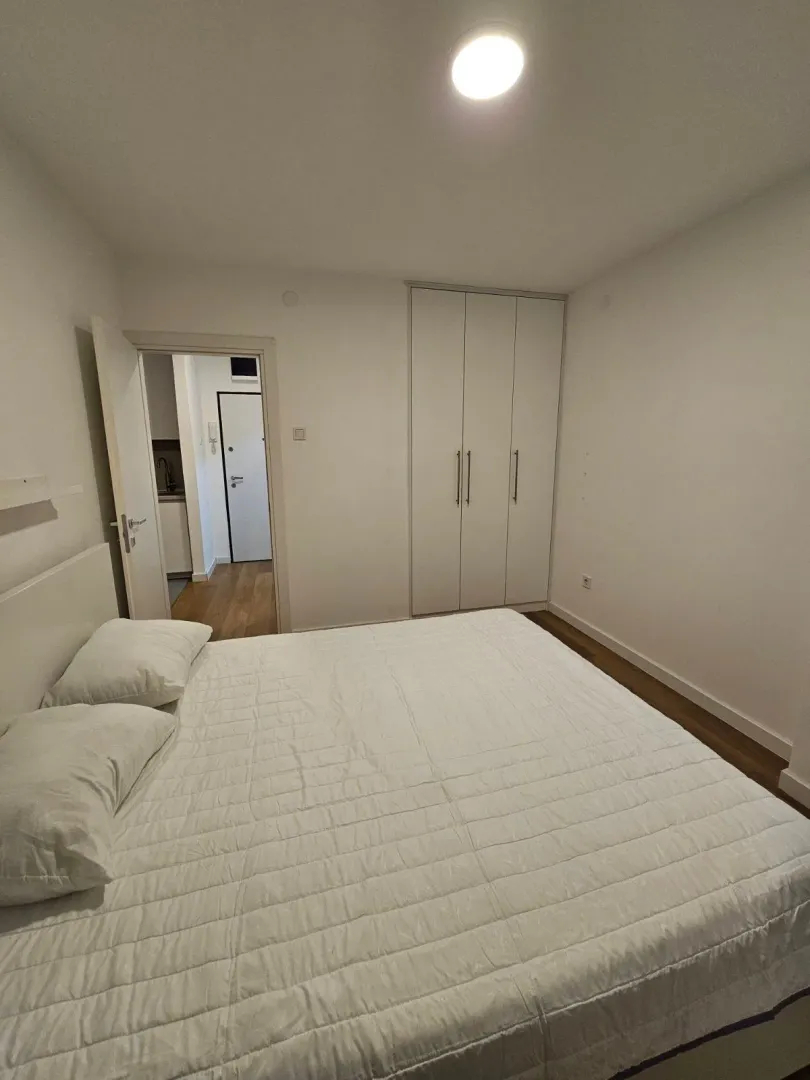 Bright bedroom with a double bed and a fitted wardrobe.