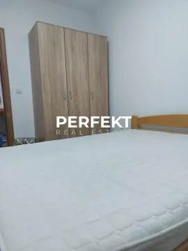 Bedroom with a double bed and wooden wardrobe. - image 9