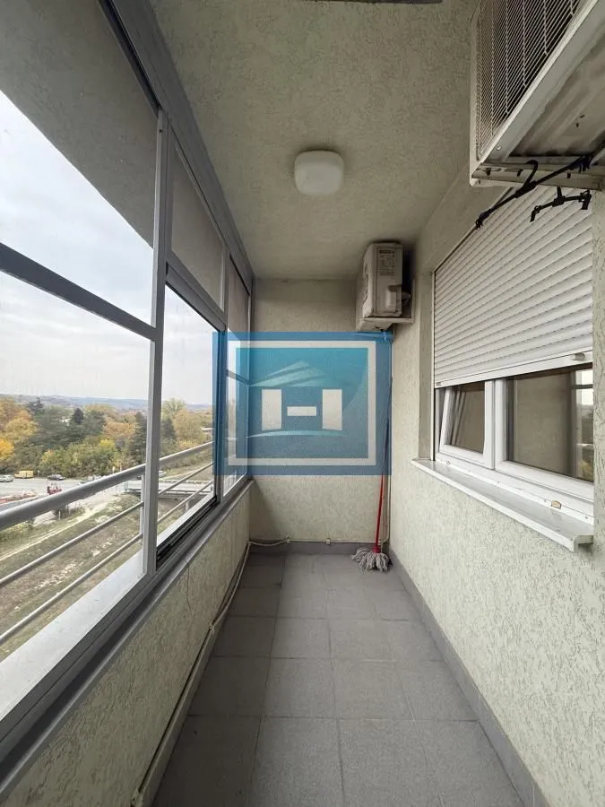 Enclosed balcony with a view of the surroundings.