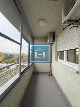 Enclosed balcony with a view of the surroundings. - image 6