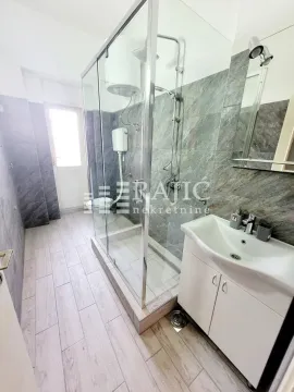 Modernly equipped bathroom with a walk-in shower and vanity unit. - image 9