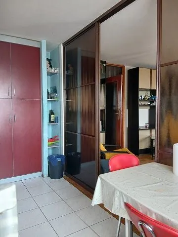 Dining area with a table and chairs connected to the kitchen.