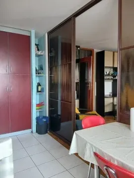 Dining area with a table and chairs connected to the kitchen. - image 4
